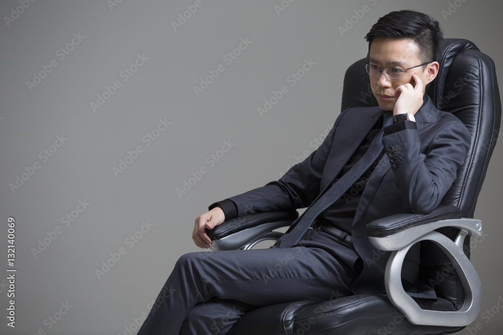 Mid adult businessman thinking