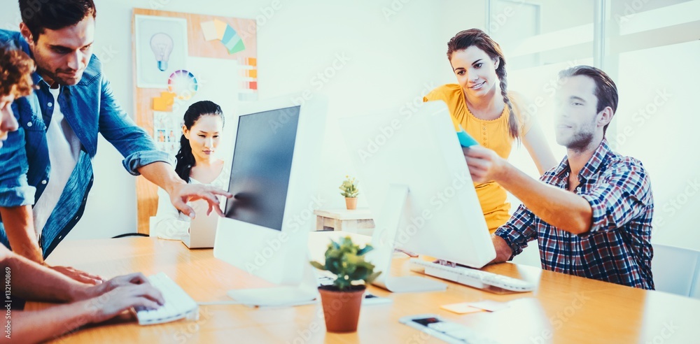 Attentive business team working on laptops