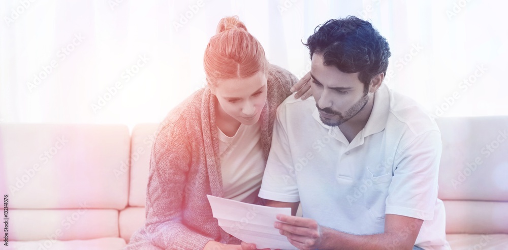 Focused couple reading a letter