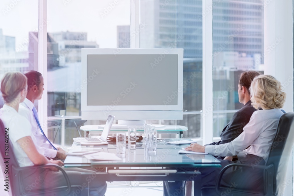 Group of business people looking at a screen