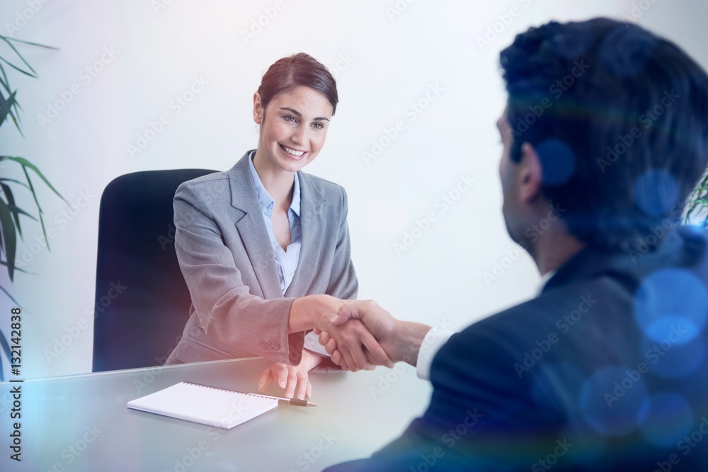 Manager shaking the hand of a customer