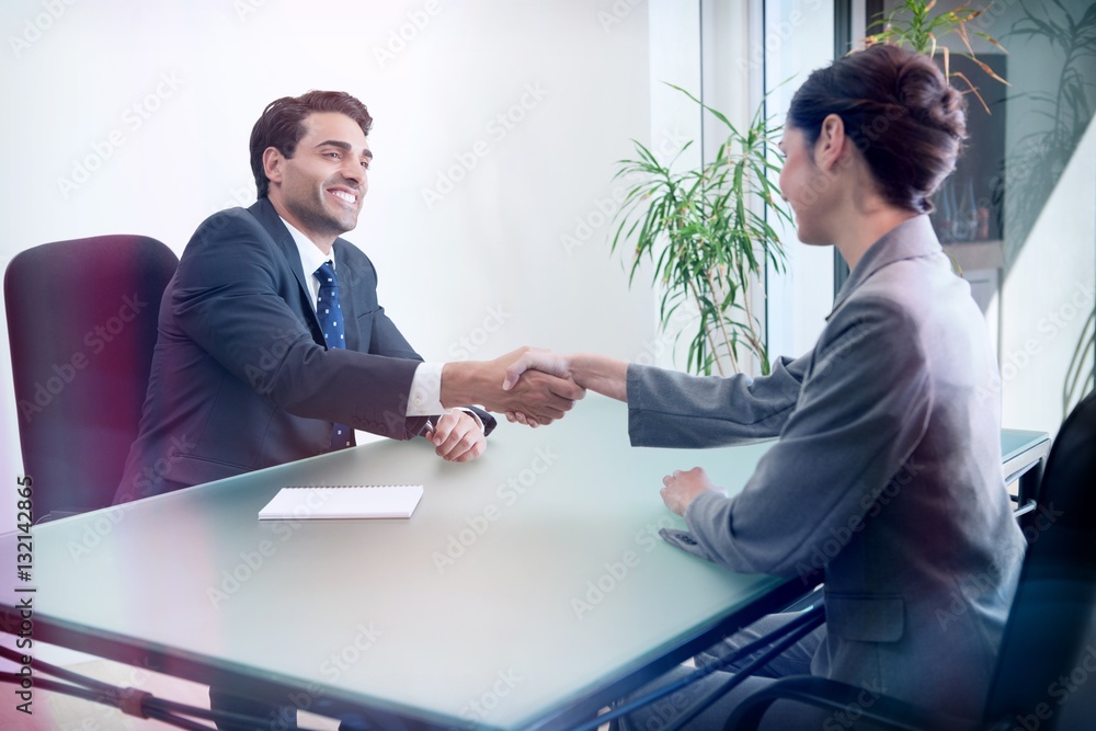 Smiling manager interviewing a good looking applicant