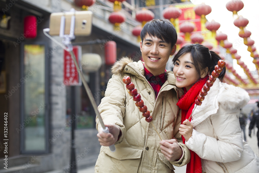 Young couple taking self portrait with a smart phone