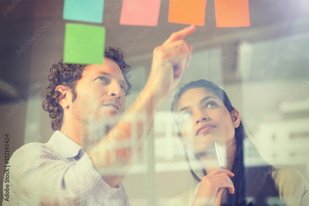 Business people reading adhesive notes