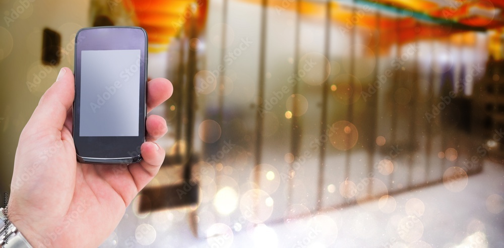 Composite image of hand of a businessman holding mobile phone 3d