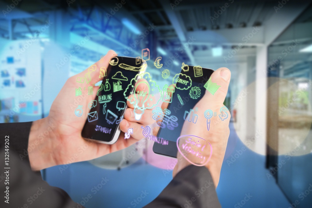 Composite image of businessman holding a phone in each hand