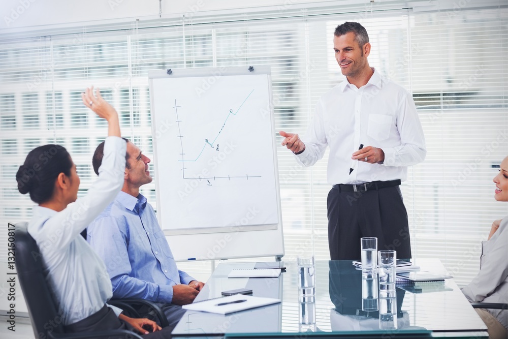 Businesswoman asking question during her colleagues presentation