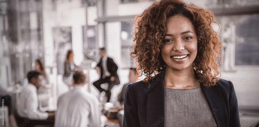 Portrait of businesswoman holding disposable coffee cup