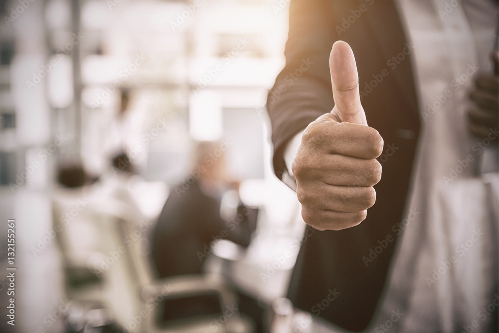 Businesswoman showing thumbs up