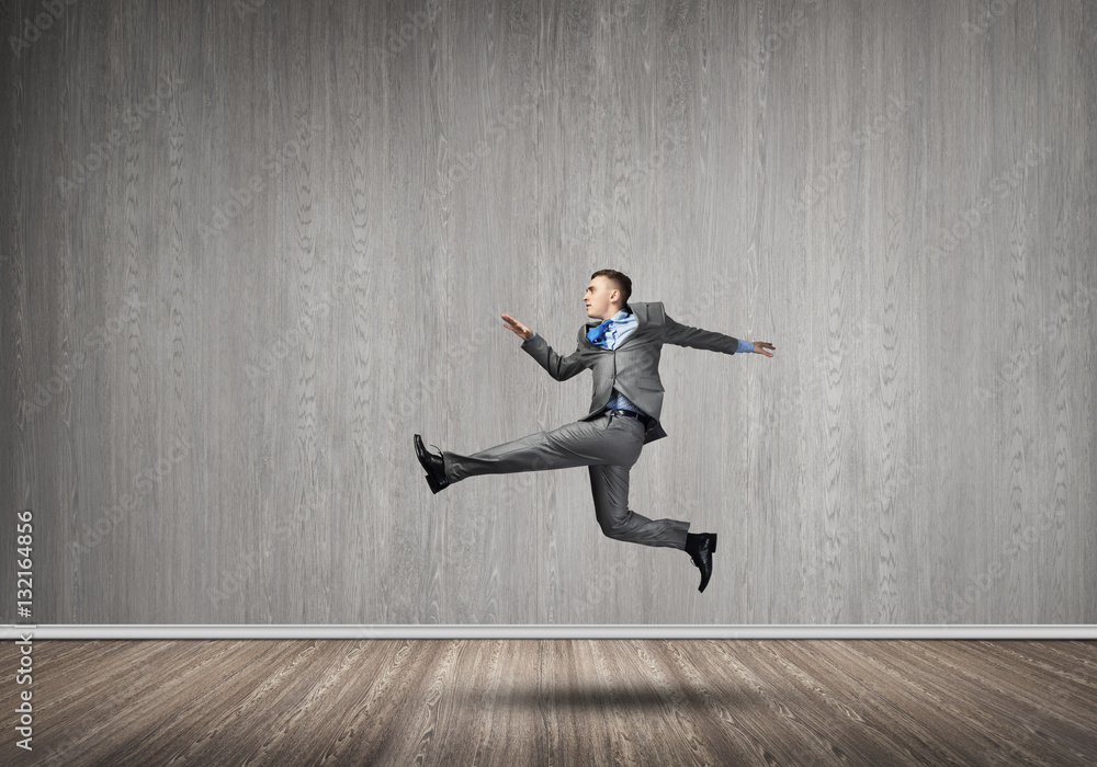 Businessman jumping high