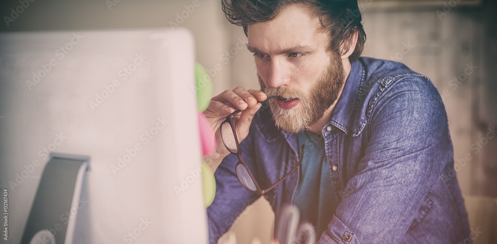 Focused hipster working at his desk