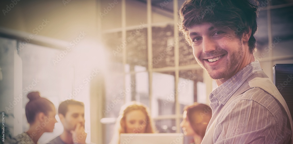 Portrait of smiling young businessman with colleagues 