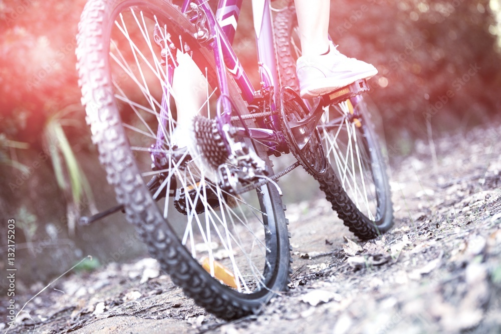 Female cyclist cycling in countryside