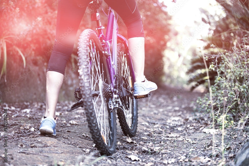 Female cyclist cycling in countryside