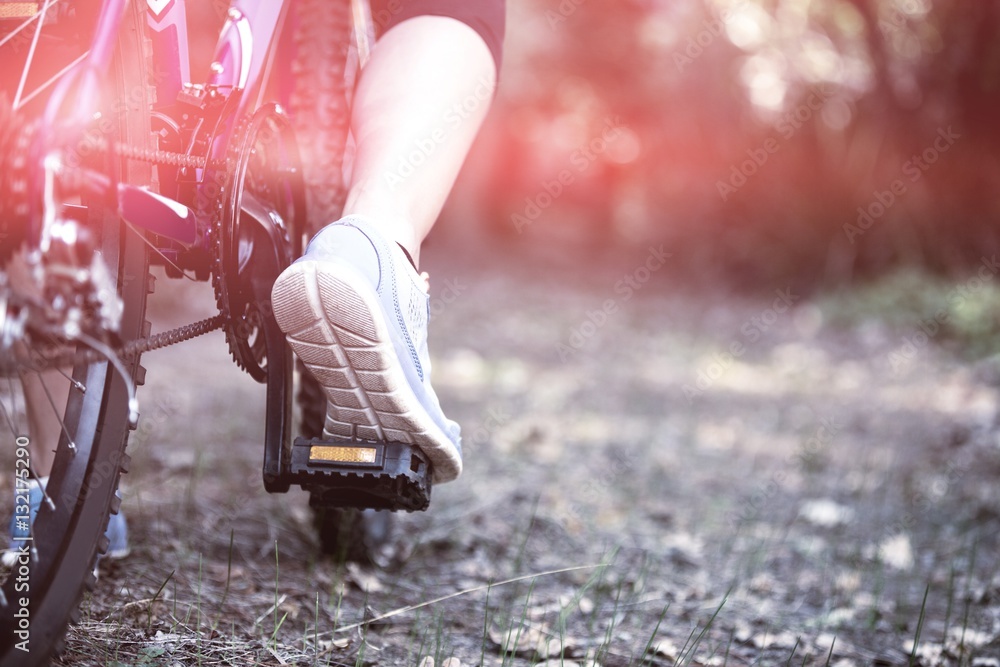 Female cyclist cycling in countryside