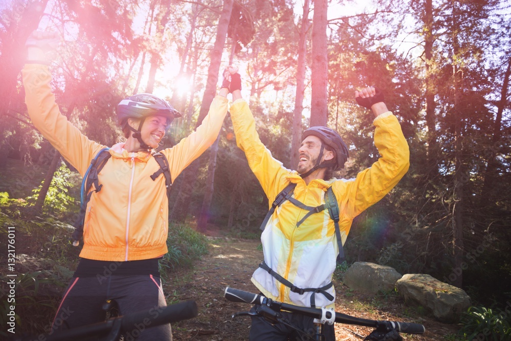 Biker couple with mountain bike in countryside