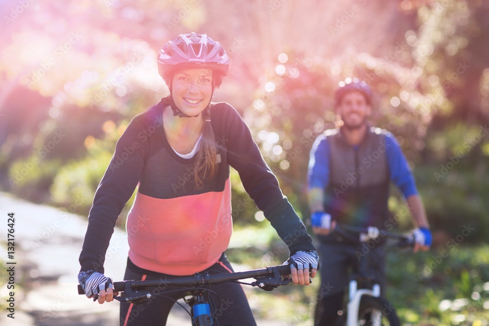 Portrait of biker couple cycling in countryside