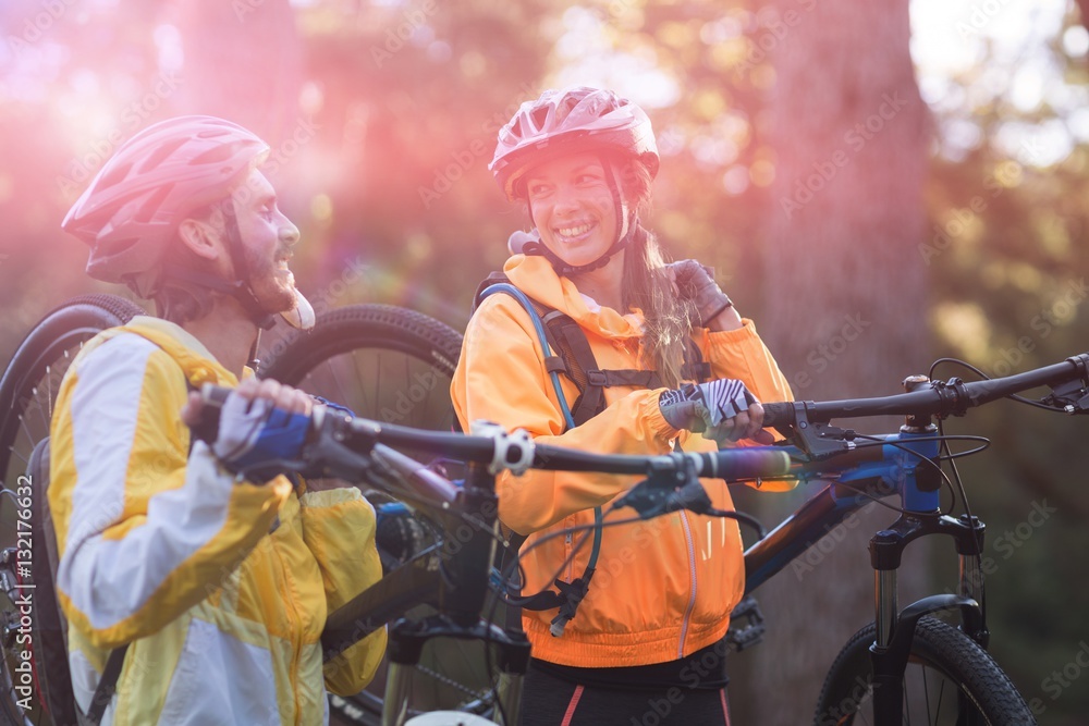 Biker couple carrying mountain bike