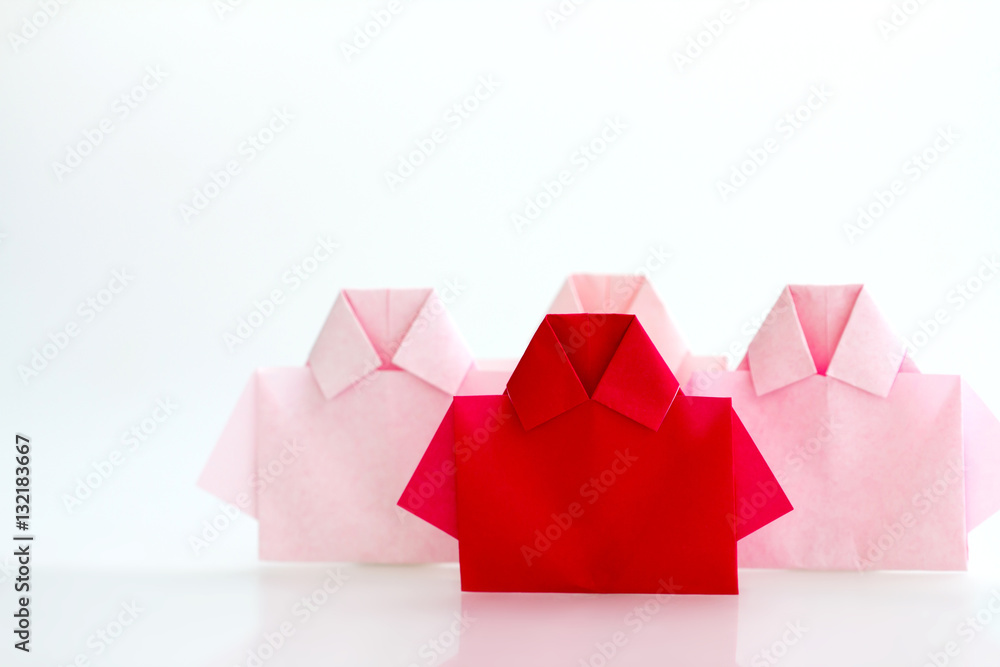 One Red among white origami shirt paper , unique individuality 