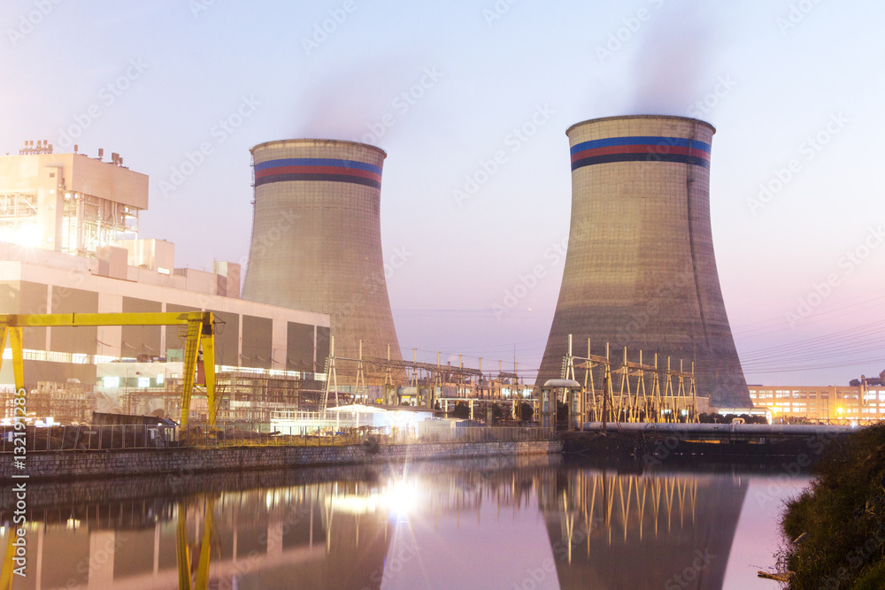 modern waterfront power plant at sunset