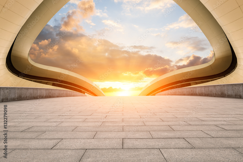 Empty floor and modern architectural passageway at sunset