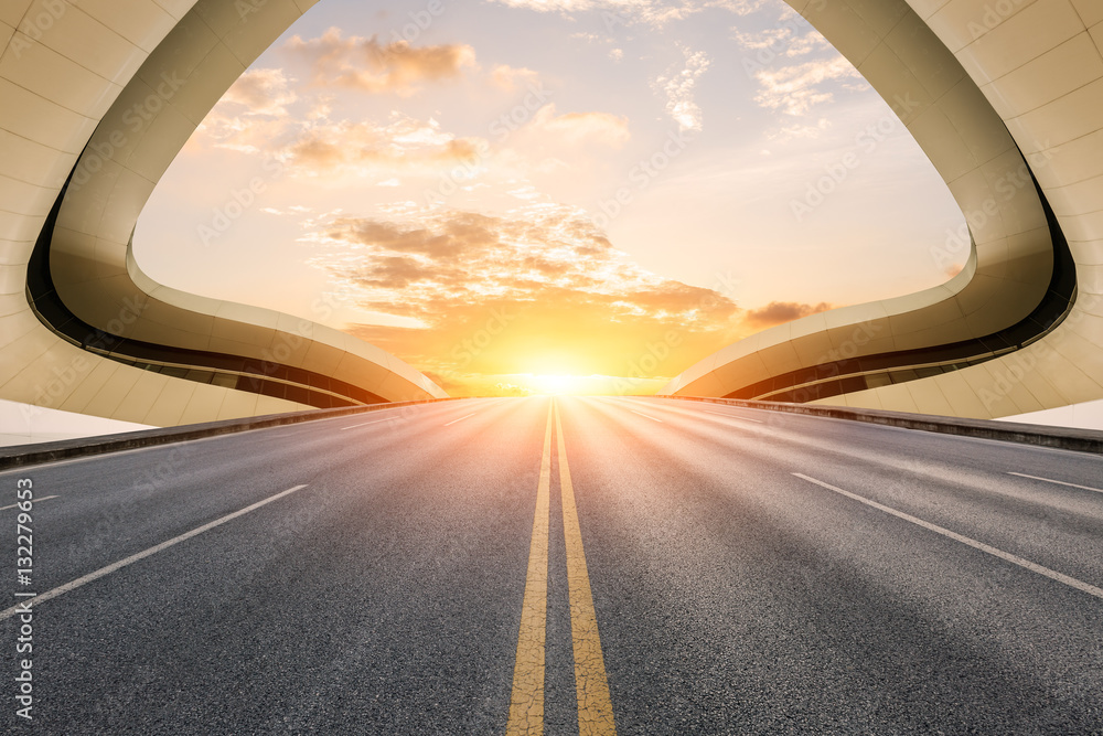 Asphalt road in front of modern bridge construction