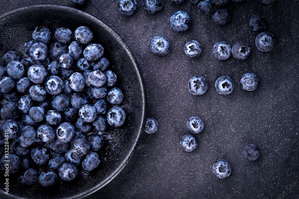  fresh picked blueberries on black stone background