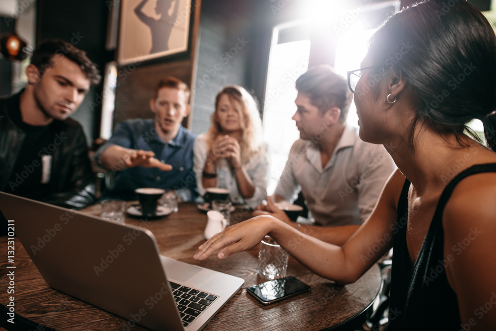 Young people with laptop at coffee shop