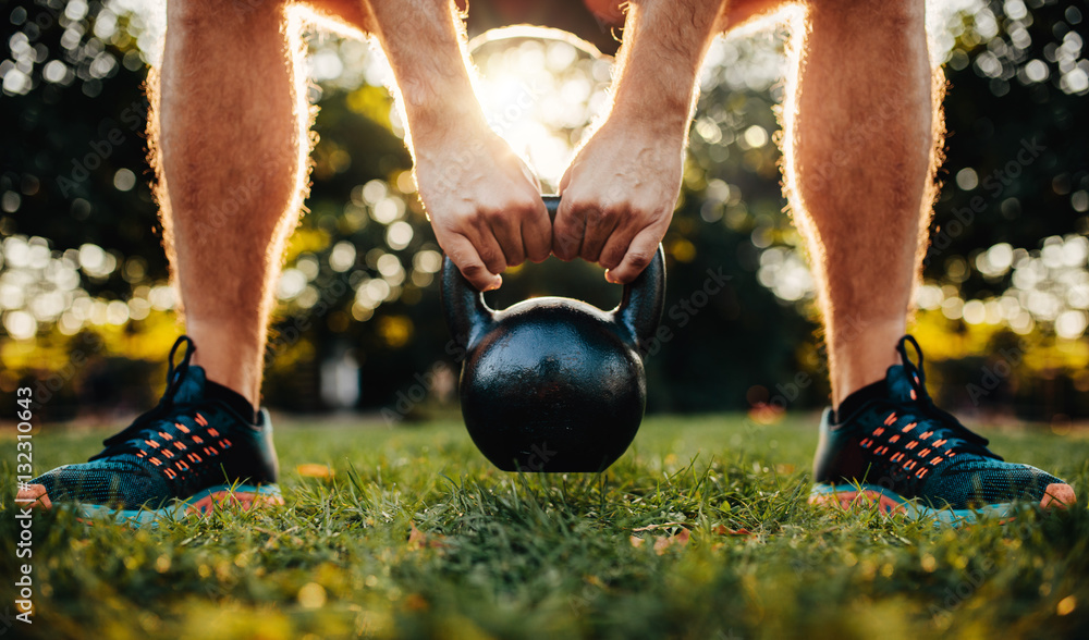 Fitness man working out with kettlebell