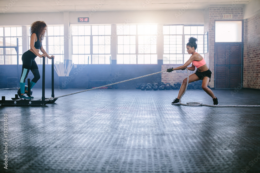 Women doing intense physical workout at gym