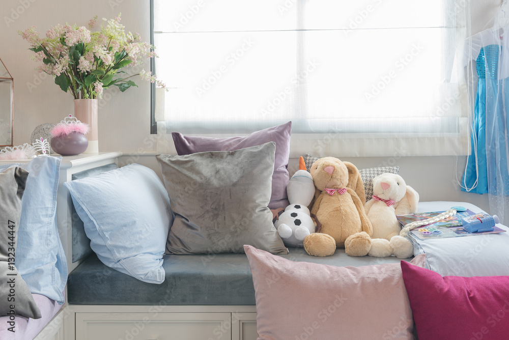 kids bedroom with dolls and set of pillows