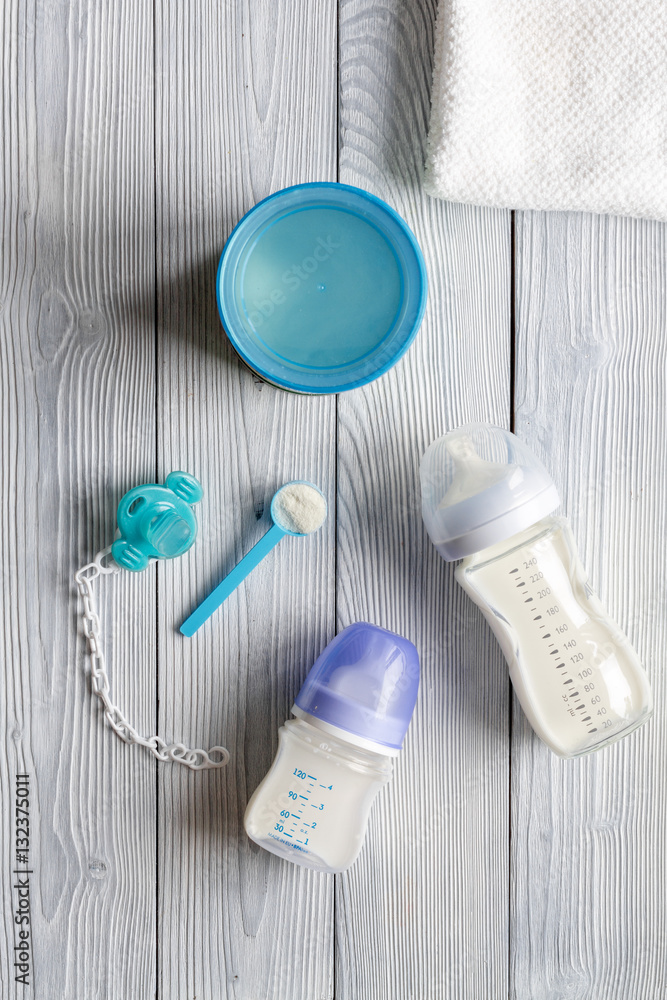 preparation of mixture baby feeding on wooden background top view