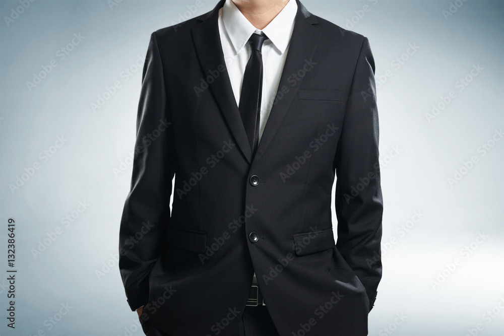 Confidence businessman in black suit , close up .