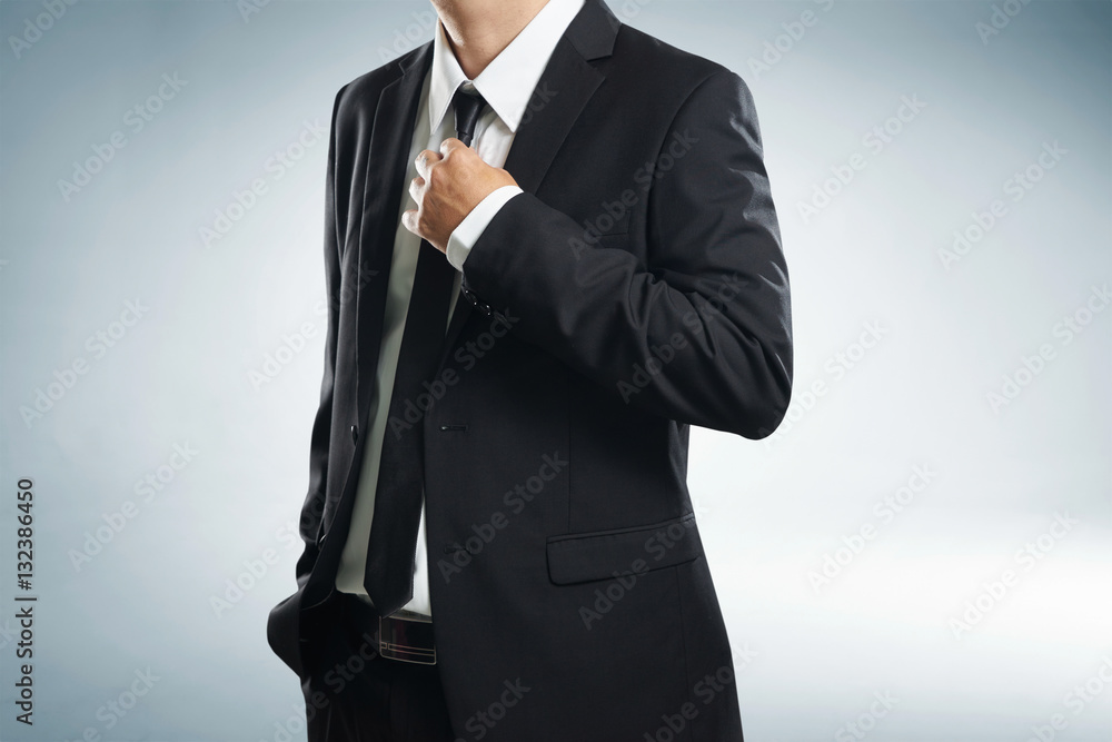 Confidence businessman in black suit , close up .