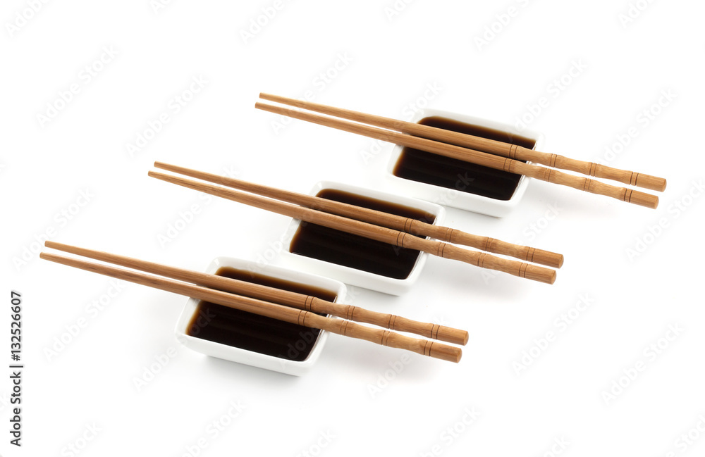 Soy sauce and chopsticks isolated on white background, with clipping path