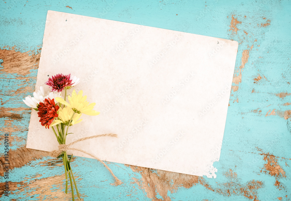 Old paper with flowers on vintage wood background