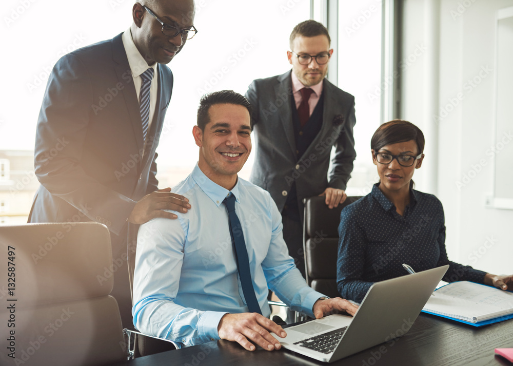 Group of four young business people in office