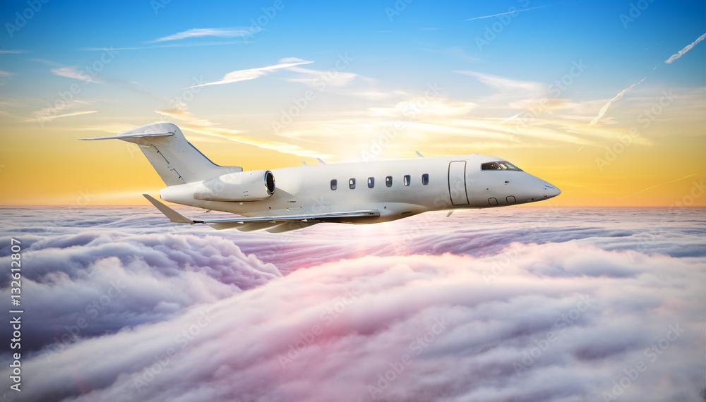 Private jet plane flying above clouds