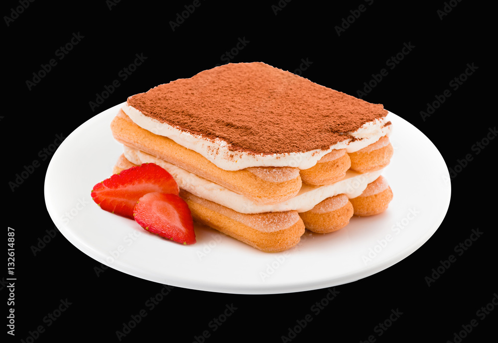 Tiramisu with strawberry on plate isolated. Black background. Clipping path