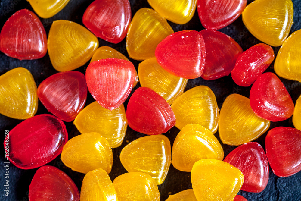 sweets and sugar candies on dark background top view