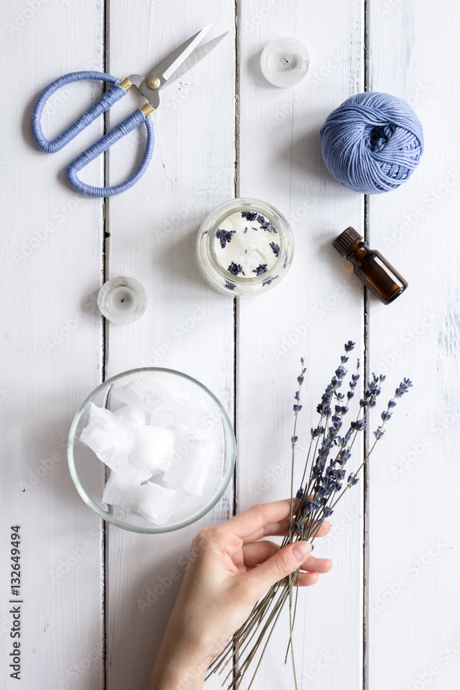 handmade candles with lavender on wooden background top view