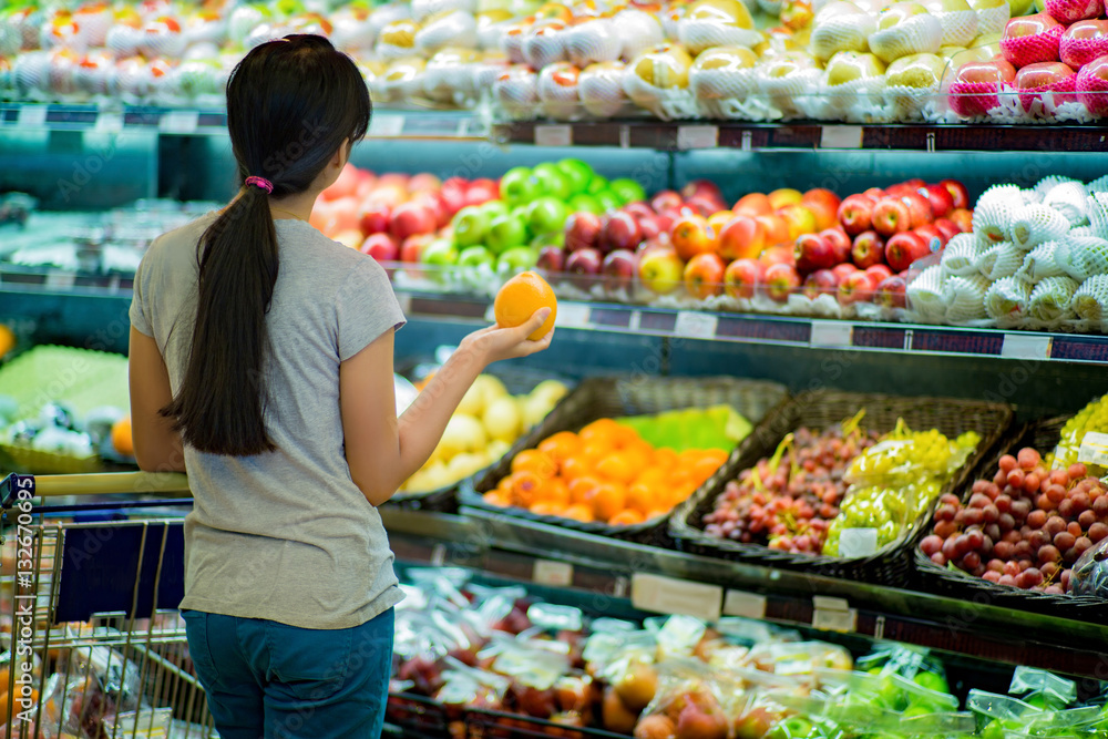 Woman are choosing fruit in supermarkets