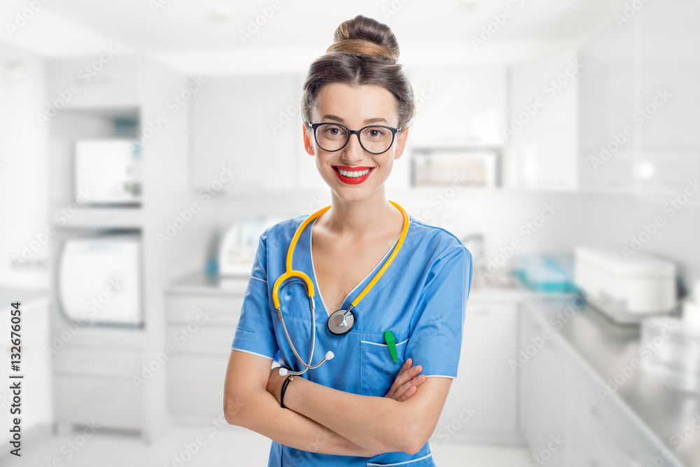 Portrait of a young female dentist in uniform with blue folder in the dental office