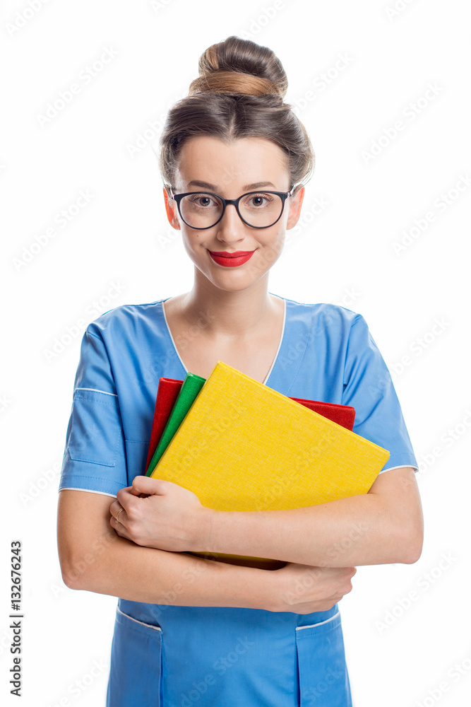 Portrait of young female student of medical school in uniform with colorful books isolated on the wh