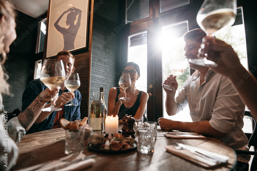 Group of friends meeting at a restaurant for dinner