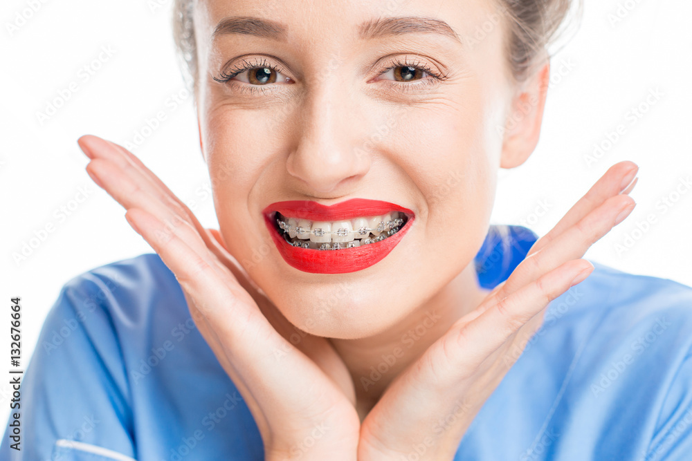 Close up portrait of a woman with tooth braces on the white background