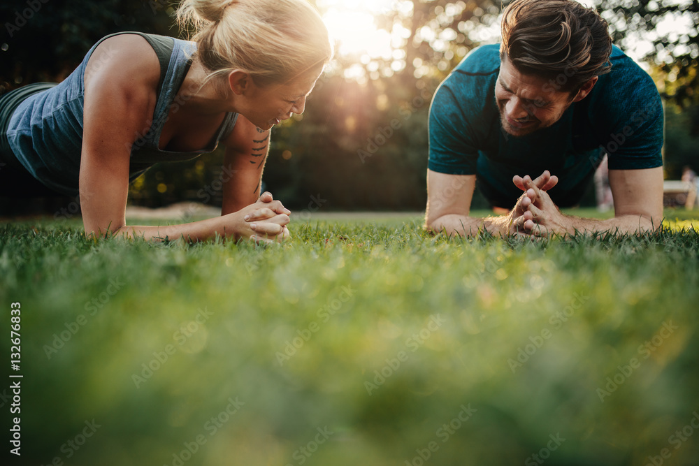 Healthy young couple exercising at park