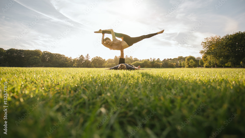 Fit young couple practising acroyoga