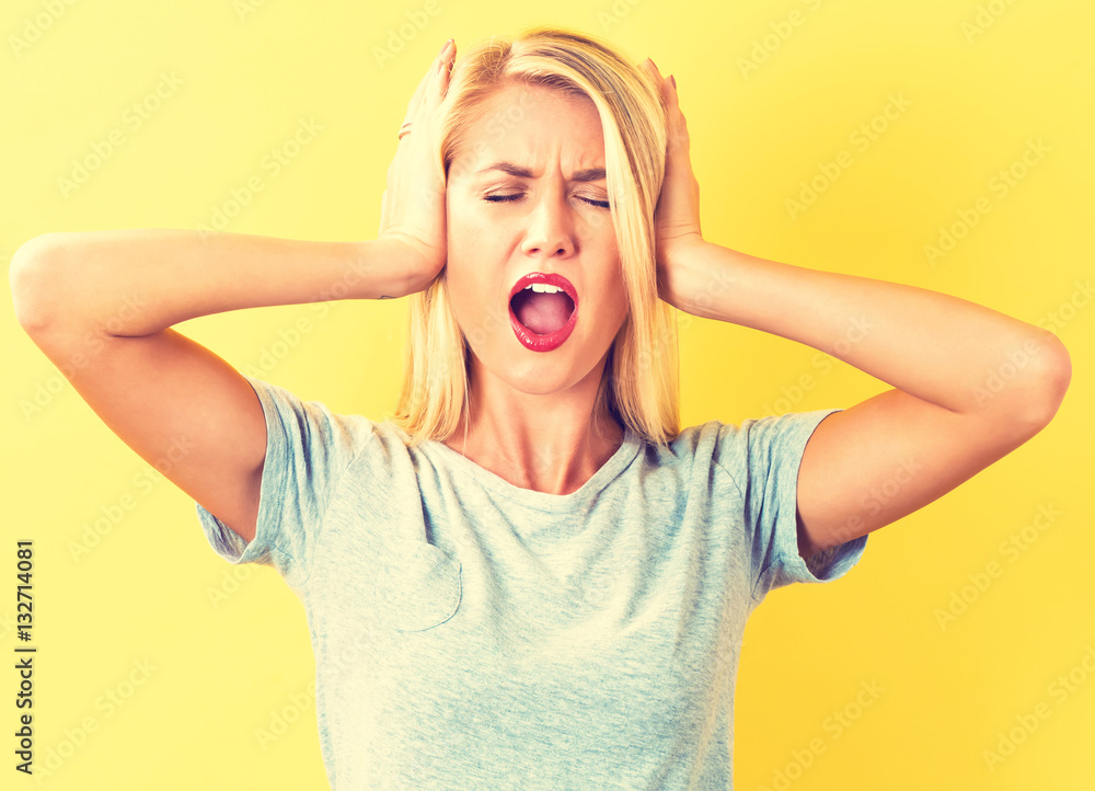 Young woman blocking her ears