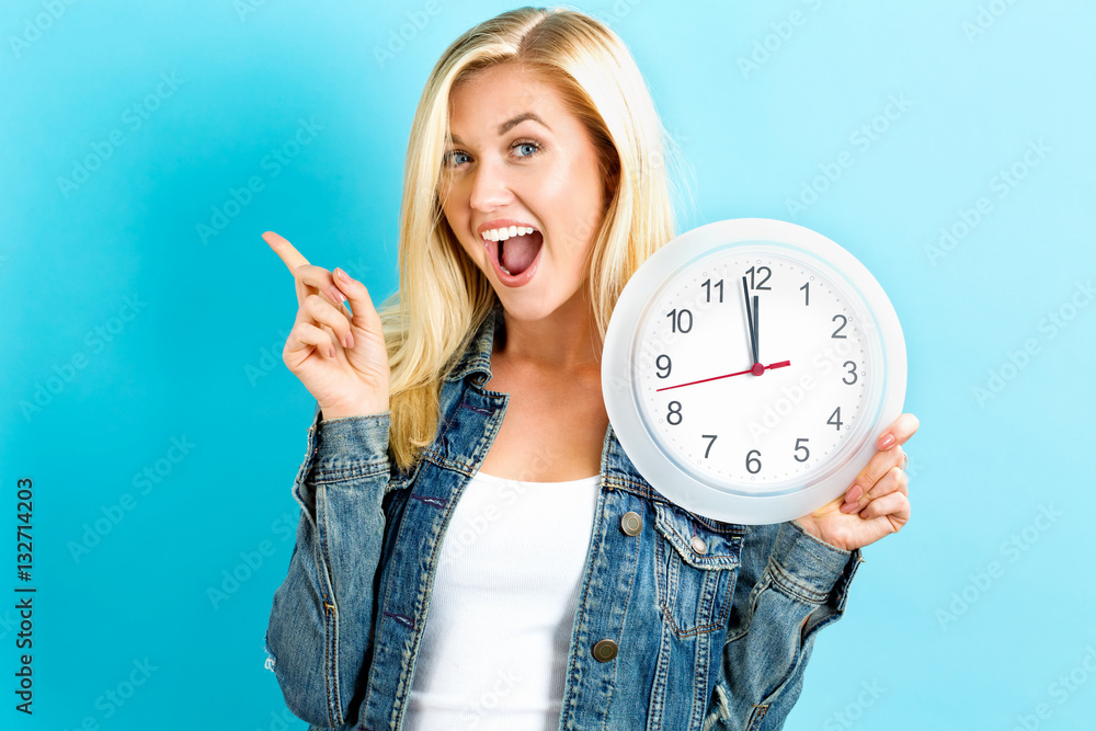  Woman holding clock showing nearly 12